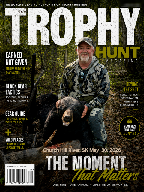Two hunters with large black bear at night Saskatchewan