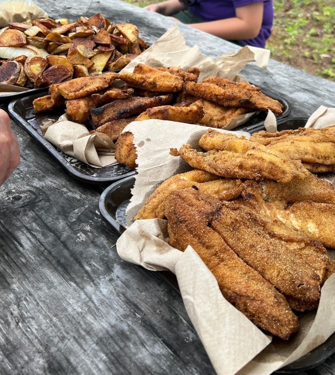 Food at outdoor picnic table shore lunch