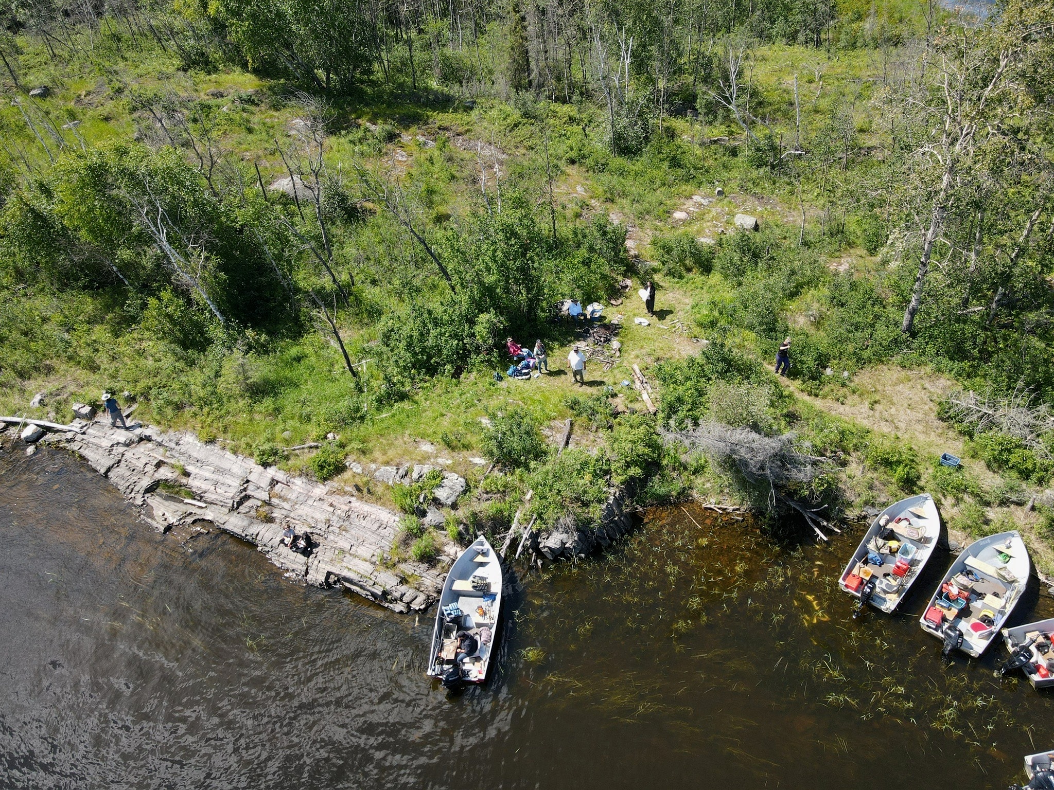 Aerial view of boats pulled up to shore for a shore lunch gathering