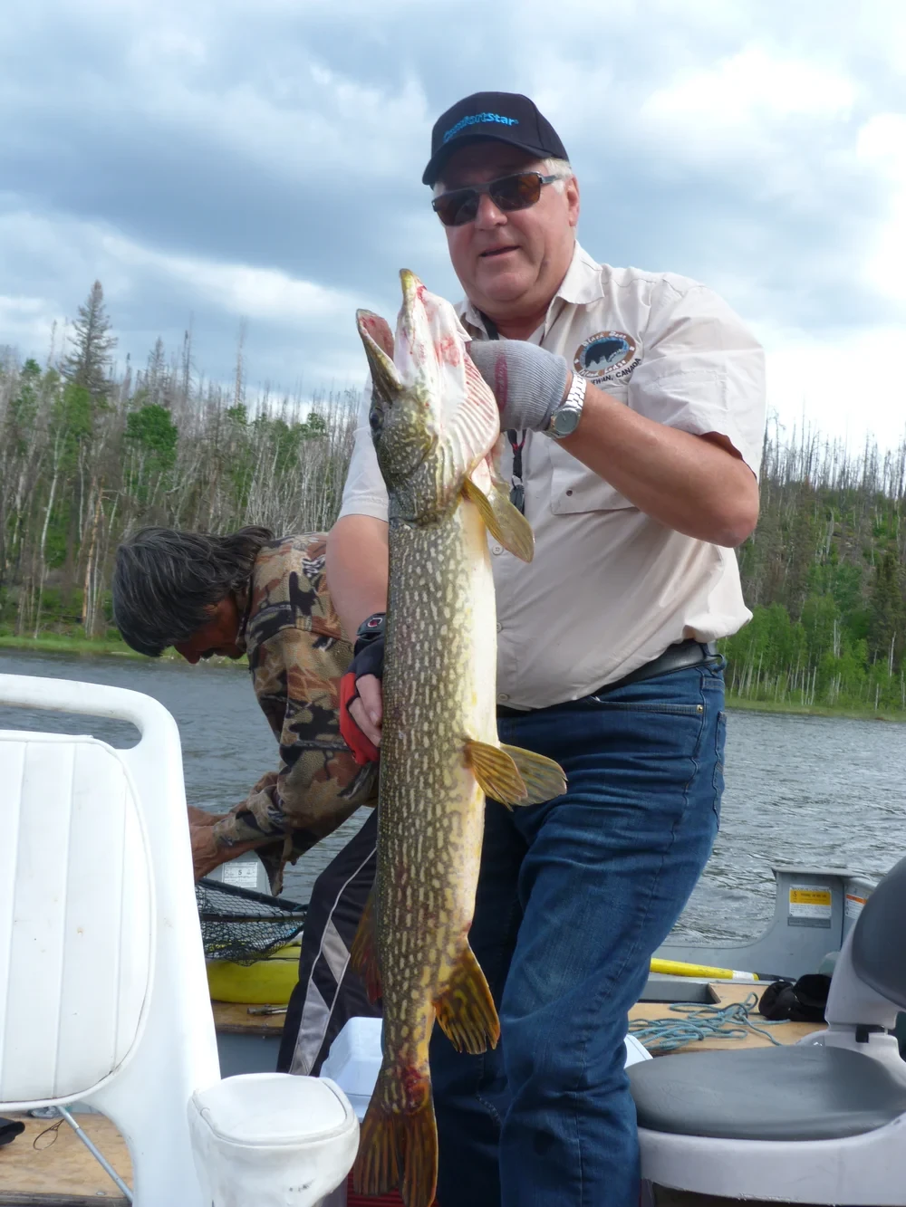 Angler with a large Northern Pike, sunny day on the Churchill River