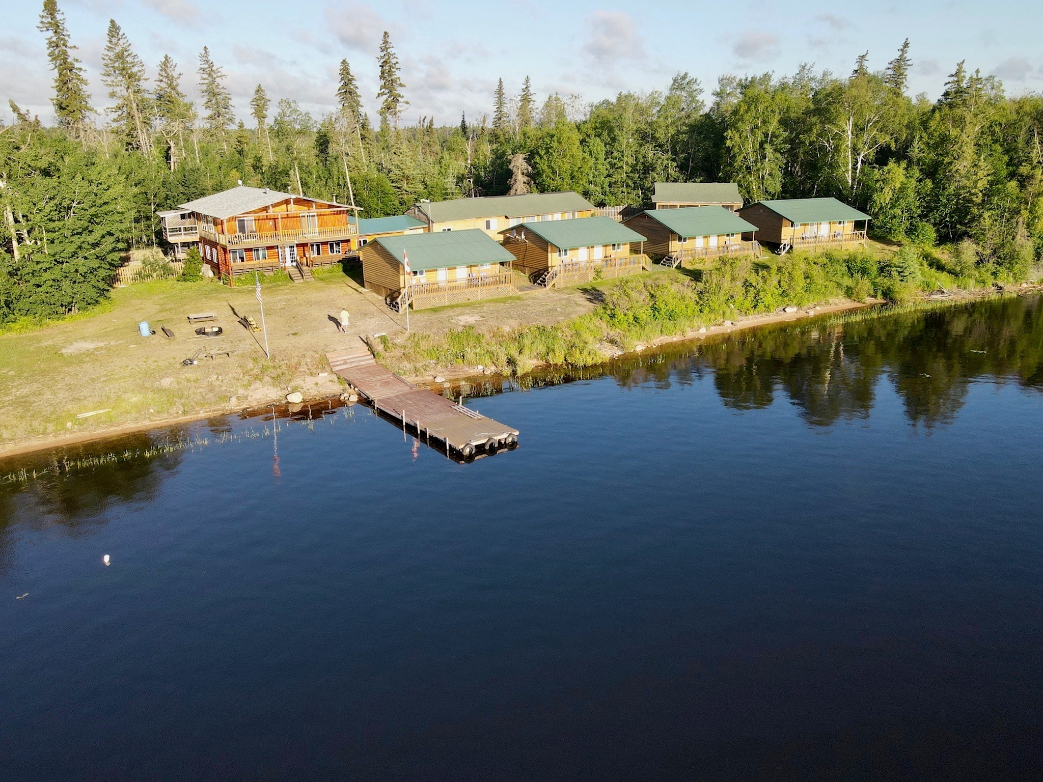Aerial drone view of Black Bear Island Lodge complex with dock and boreal forest